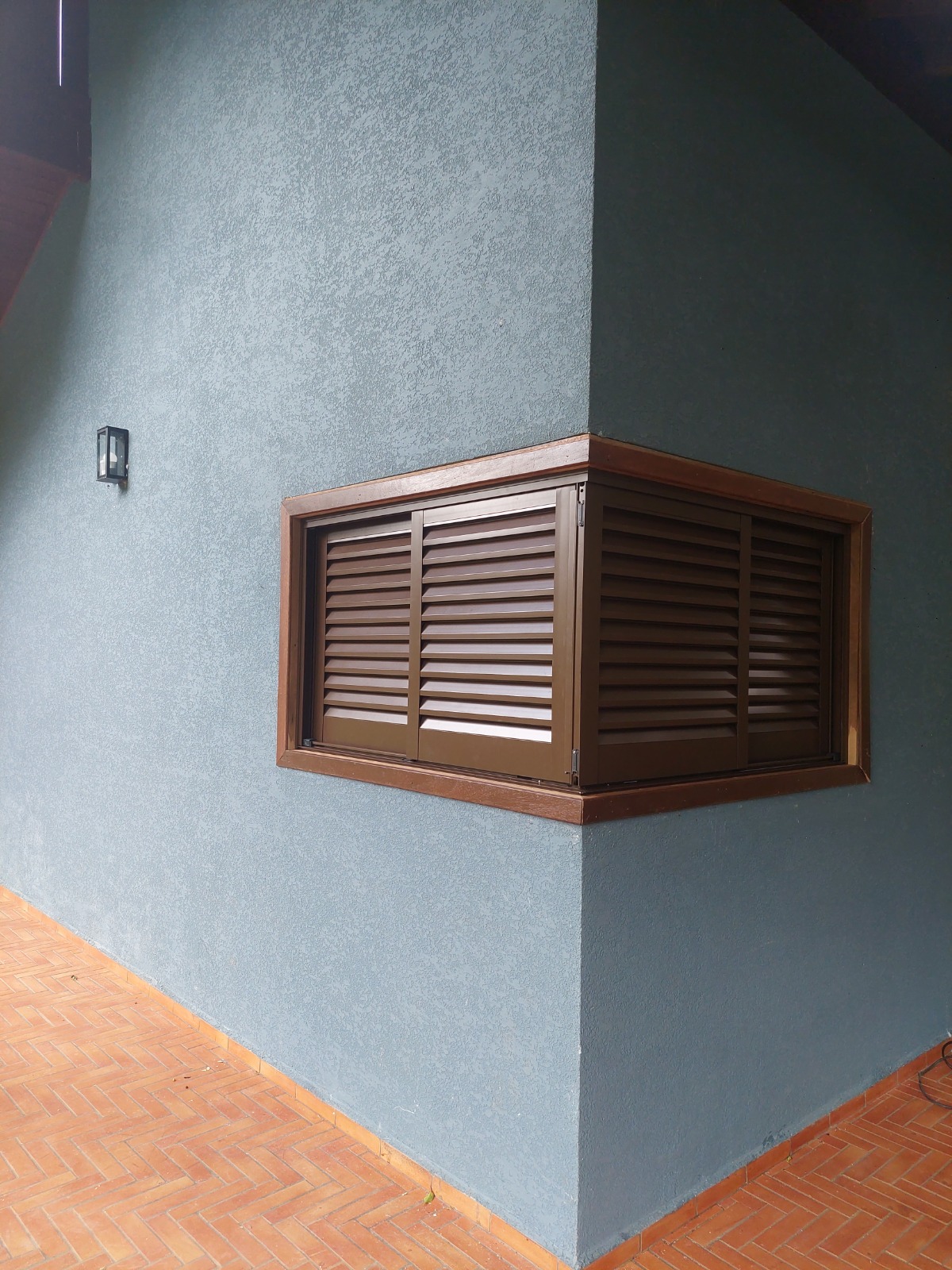 Janela de canto com venezianas vista pelo exterior